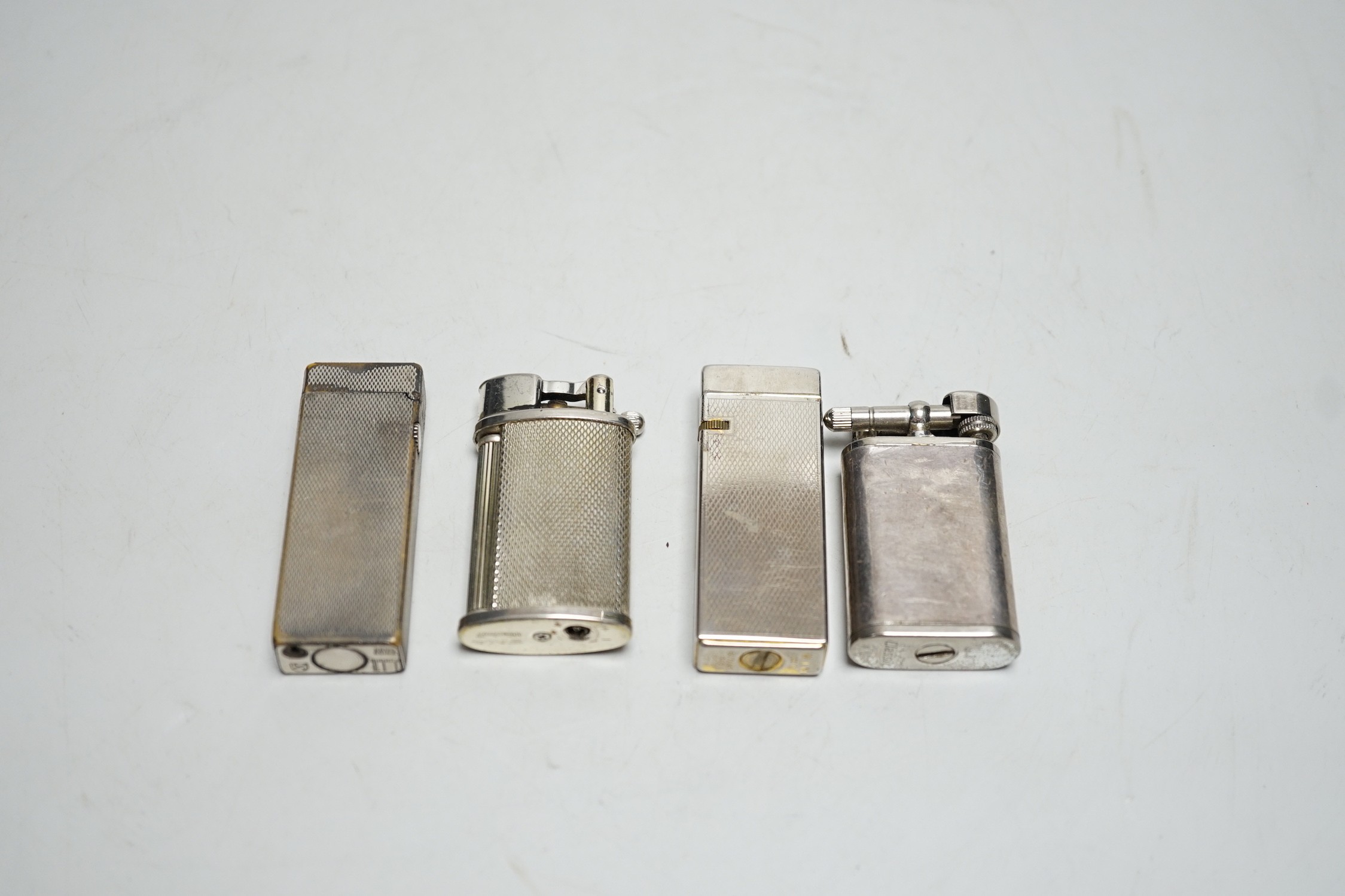 A Dunhill Rollegas lighter and four others